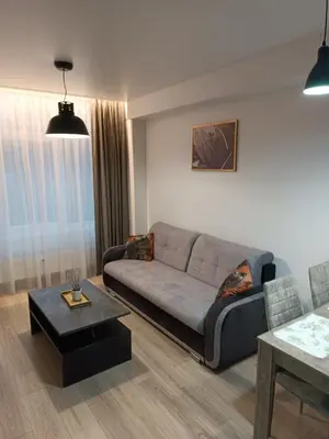 a living room with a couch and a table at Bruklinas in Šiauliai