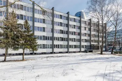 an office building with snow in front of it at River To The City - Self check in in Vilnius