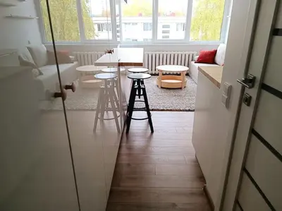 a living room with stools and a table and a couch at Stylish Studio in Central Vilnius II in Vilnius
