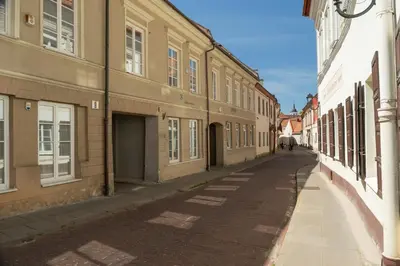 an empty street in a city with buildings at Capital's Old Town Gem in Vilnius